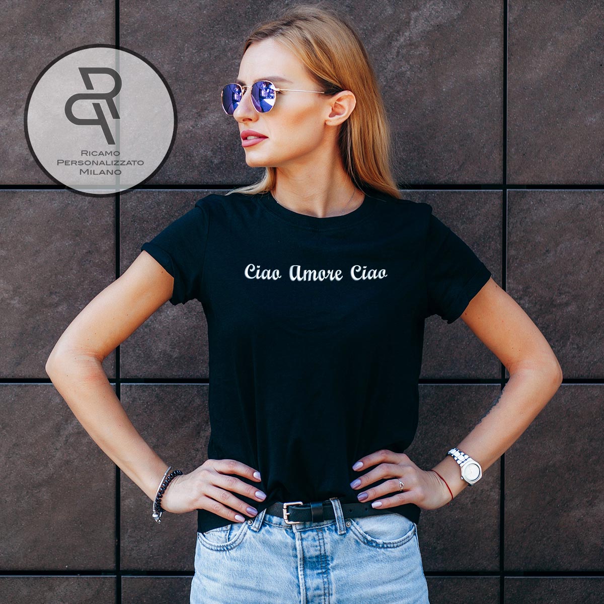 Stylish blonde girl wearing black t-shirt and glasses posing against street